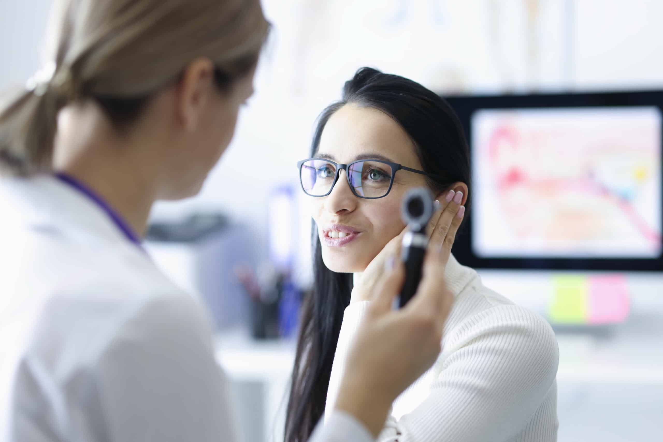 Woman Patient Holding Ear