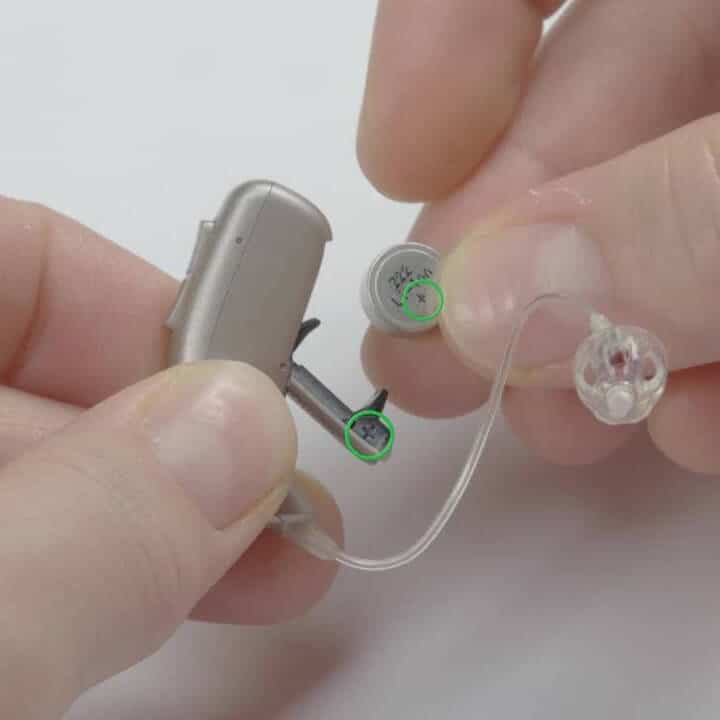 hearing aid batteries with the plus side circled